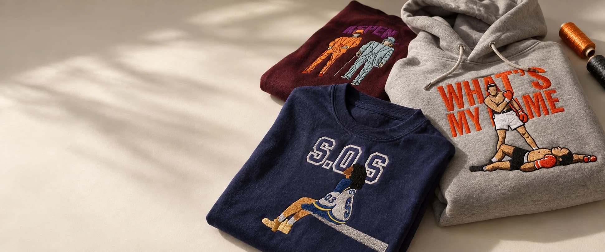 Styled embroidered shirts and hoodie featuring boxing, S.O.S., and anime designs